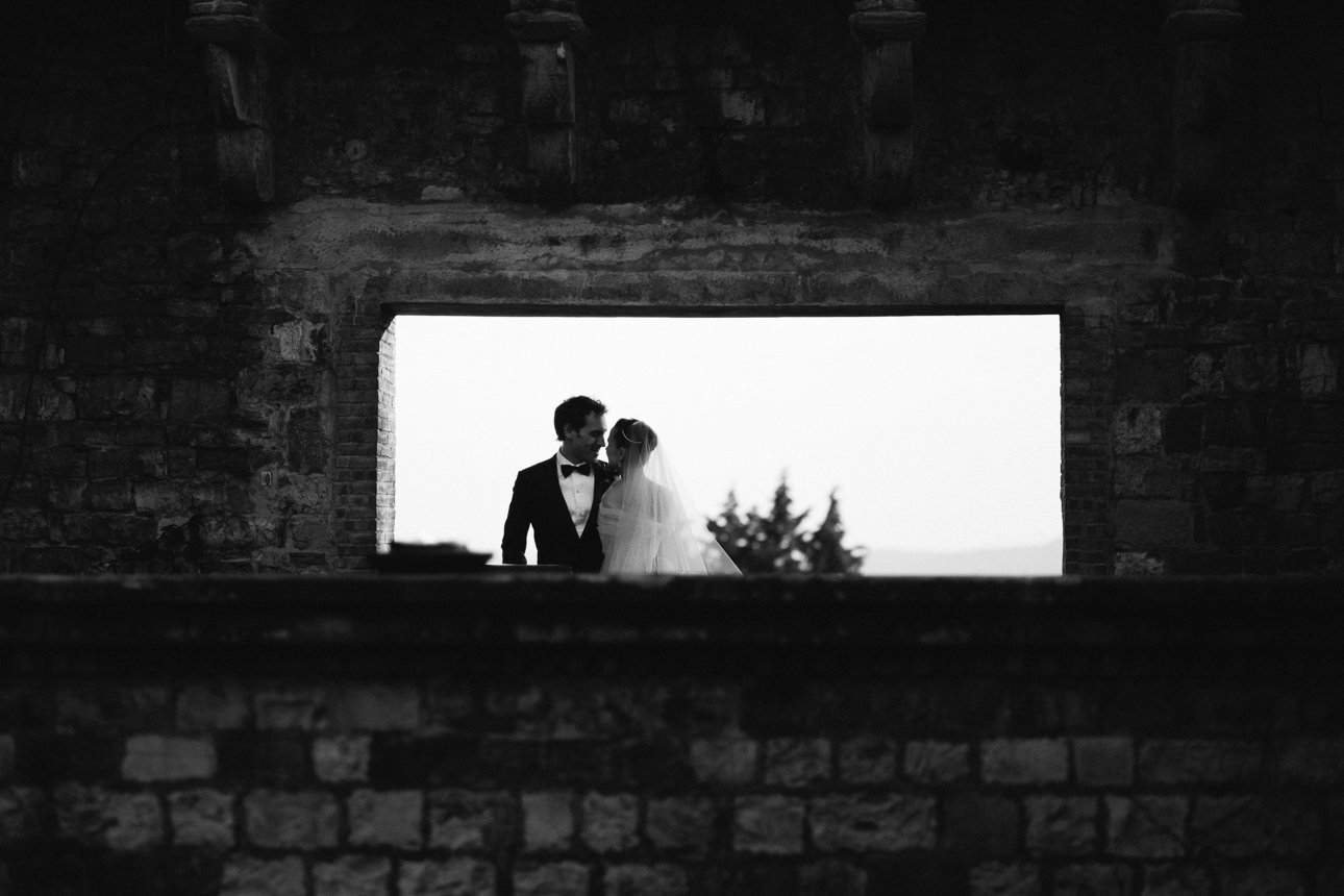 vincigliata castle wedding photographer: a couple kissing after wedding in Fiesole Cathedral