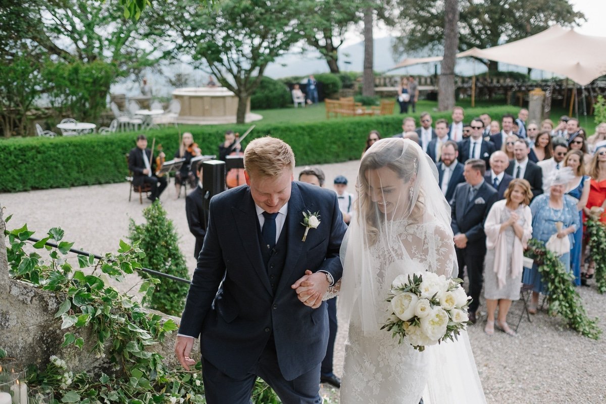 Bride and groom on the stairs at borgo pignano
