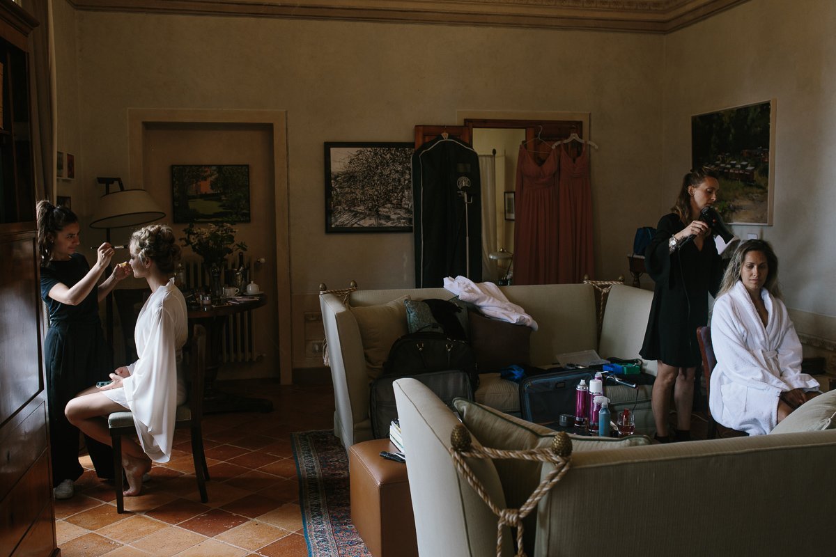 Bride and bridesmaids getting ready in a room of the villa