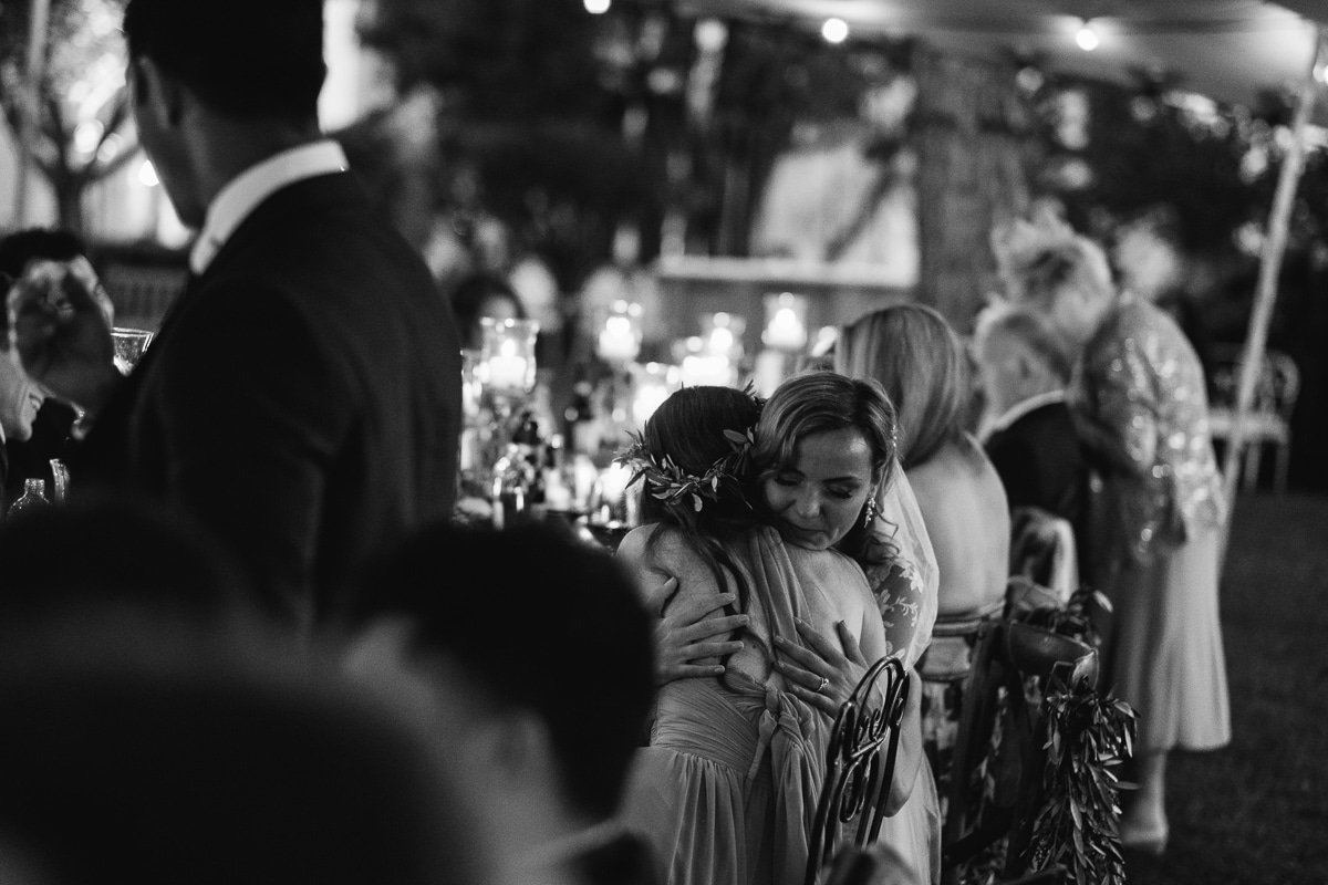 Guests laughing during the speeches, black and white