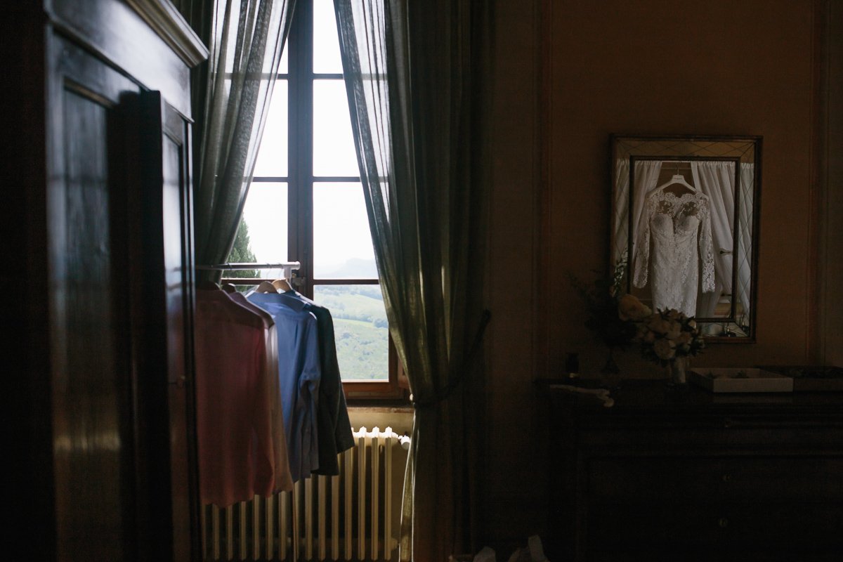 Wedding dress hanging by the window in the bridal suite
