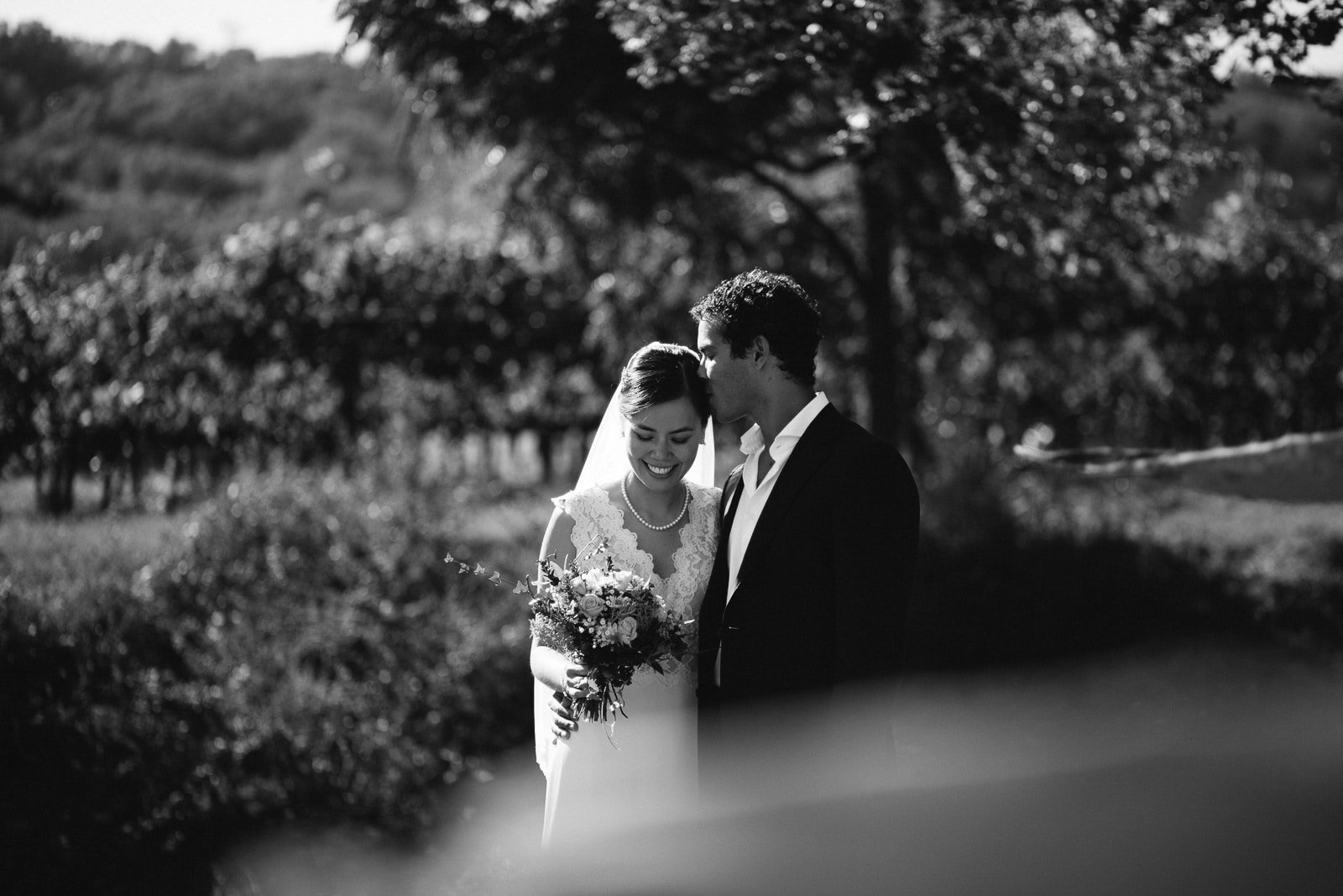 Bride and groom walking in the garden, black and white
