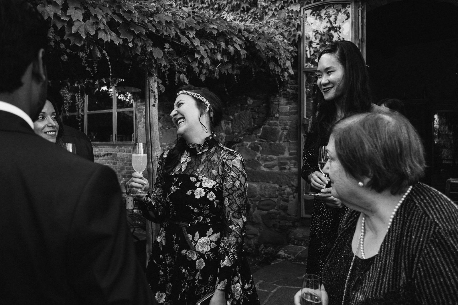 Family hugging the couple, black and white