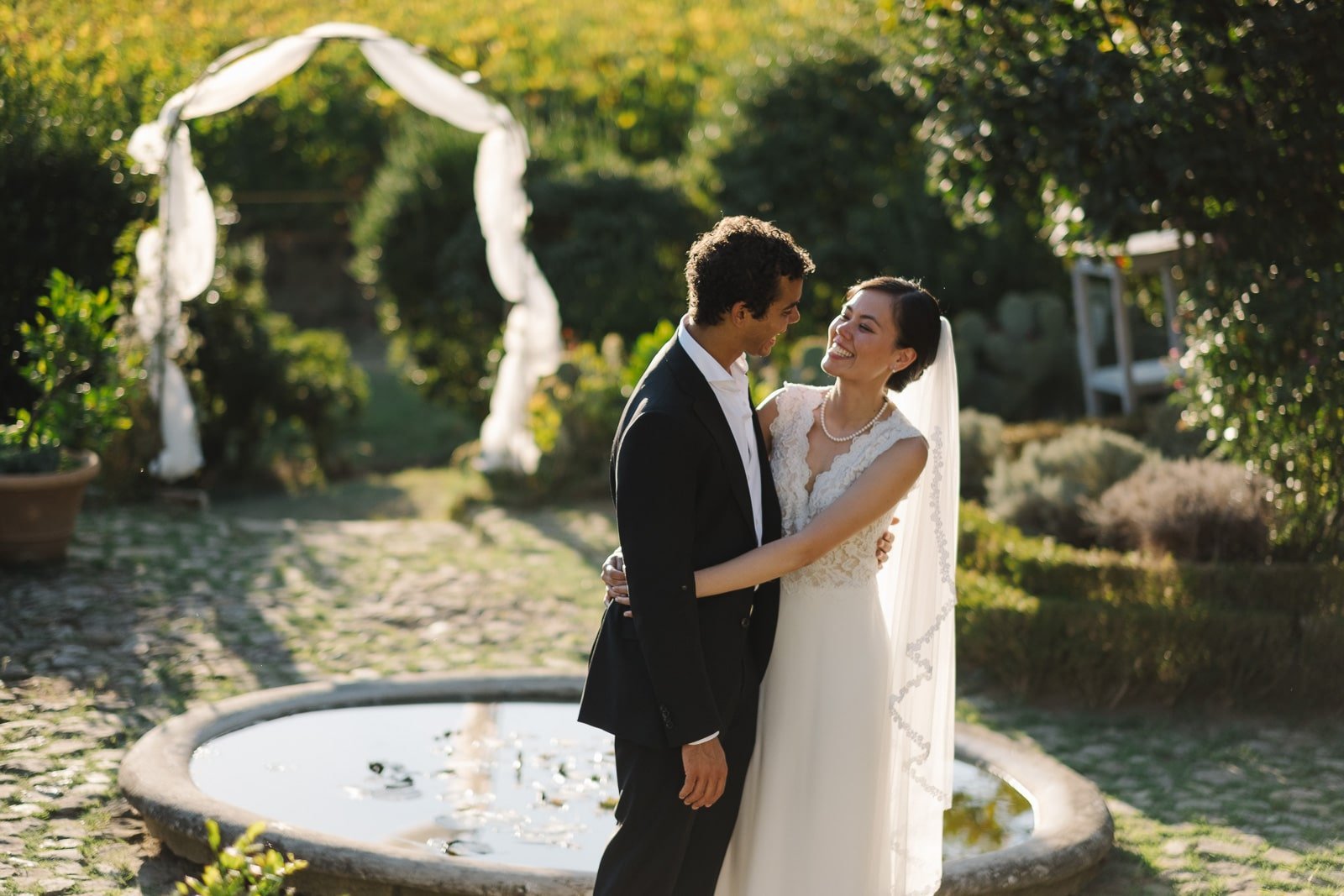 Bride and groom by the fountain