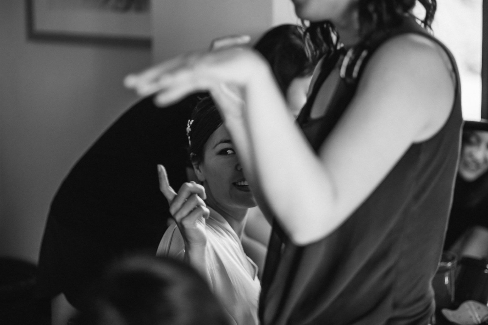 Friend helping the bride get ready