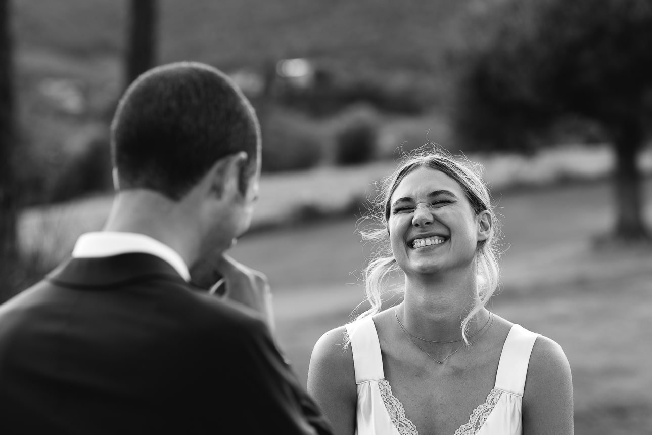 Bride laughing with the groom at Casa Olivi, Treia, black and white