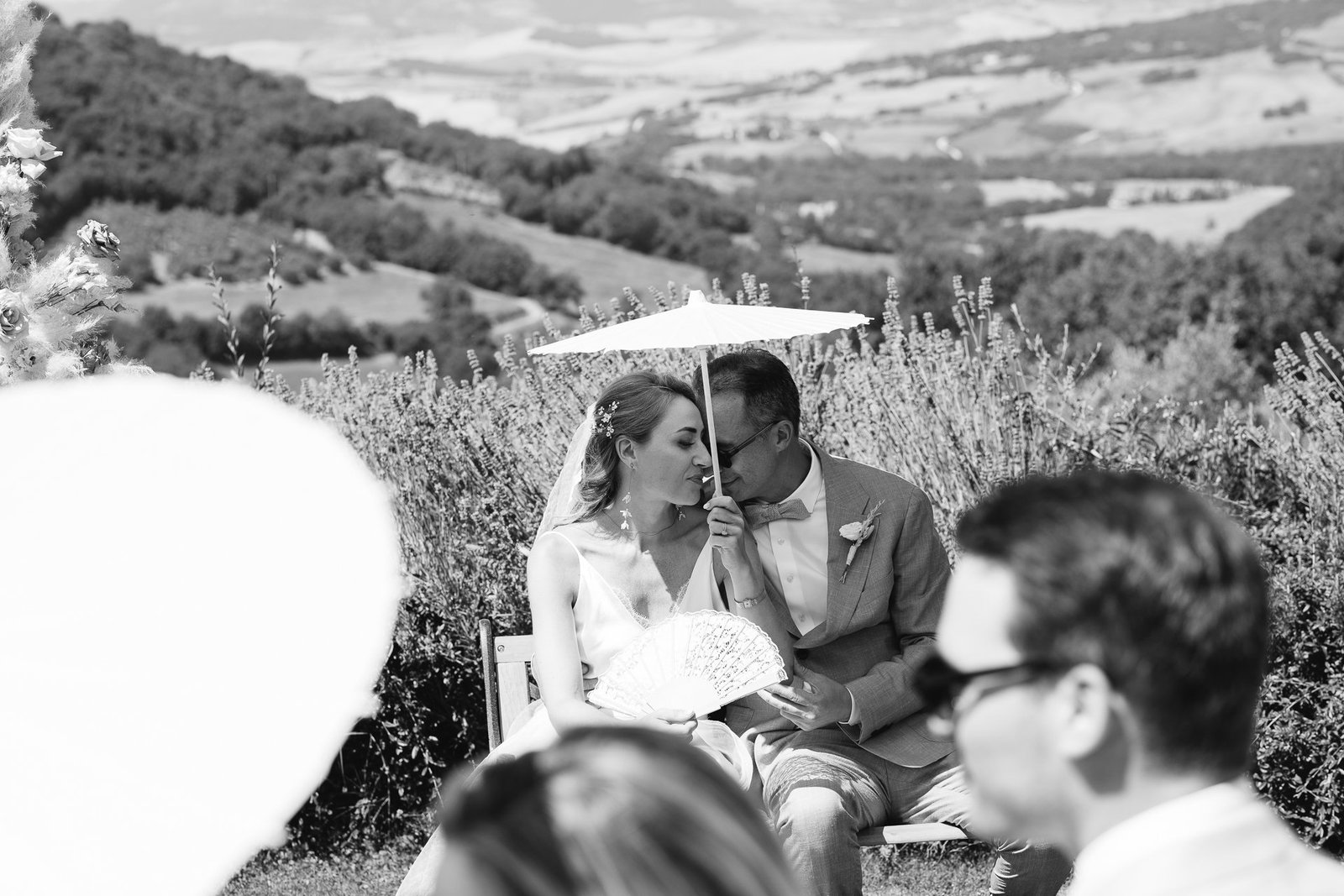 bride and groom parasols during the ceremony, black and white