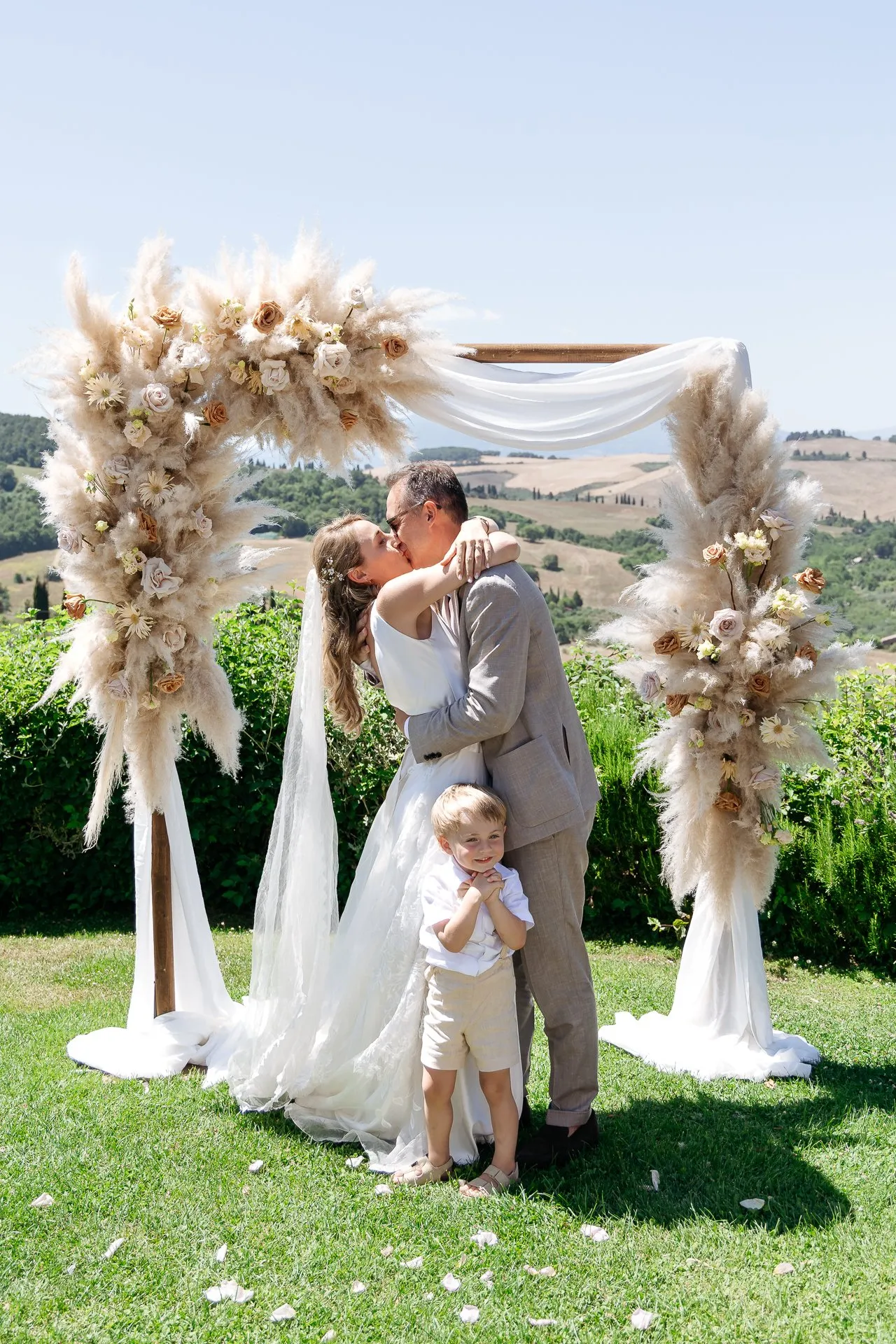 bride and groom are kissing during their wedding ceremony at Terre di Nano, Pienza