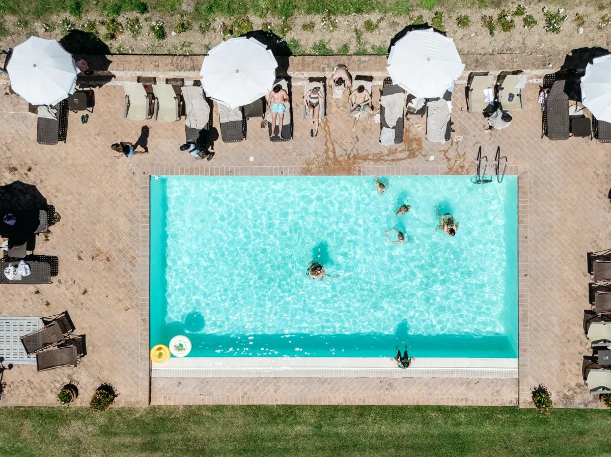 guests by the pool before the wedding ceremony at pienza tuscany
