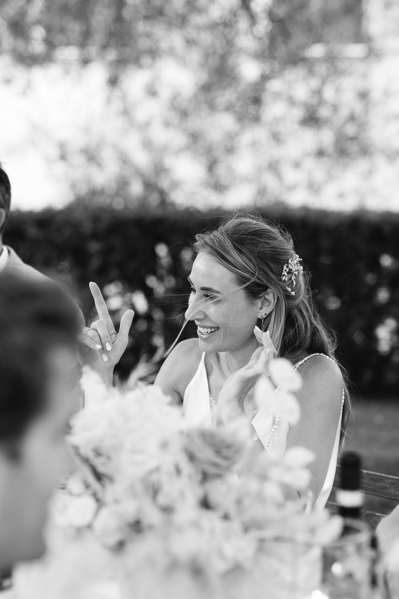 Evelien laughing at dinner, black and white