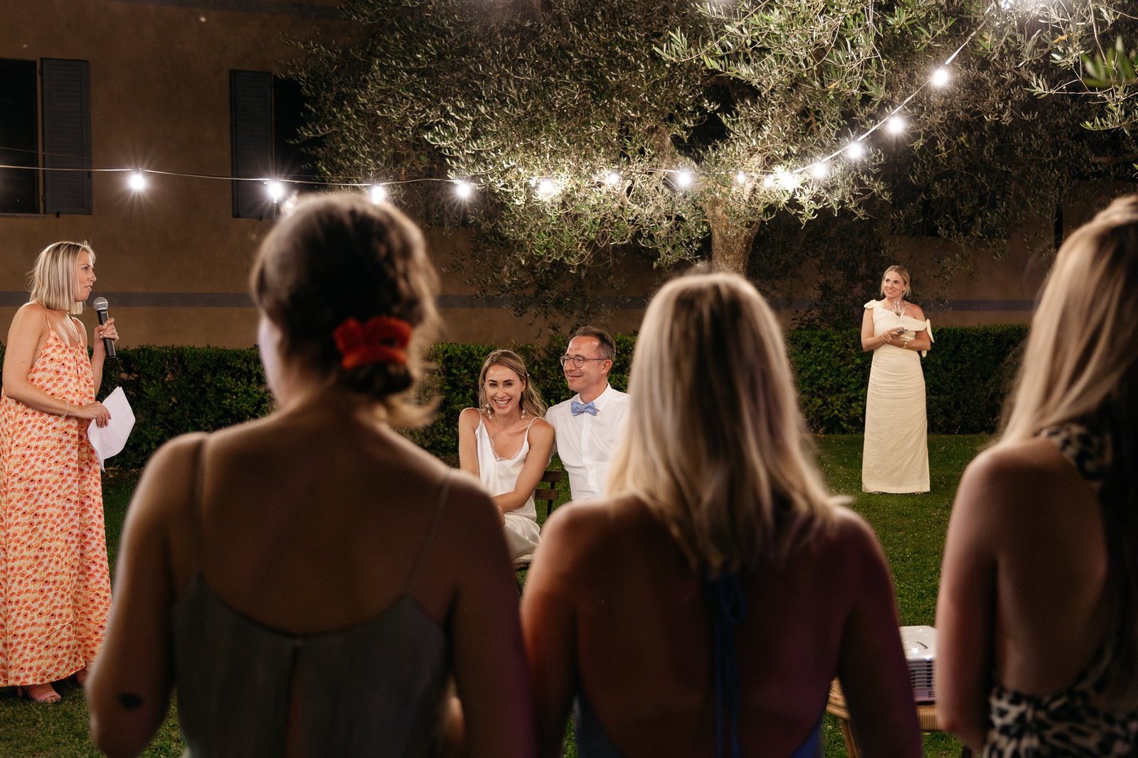 Guests listening to the speeches under the lights