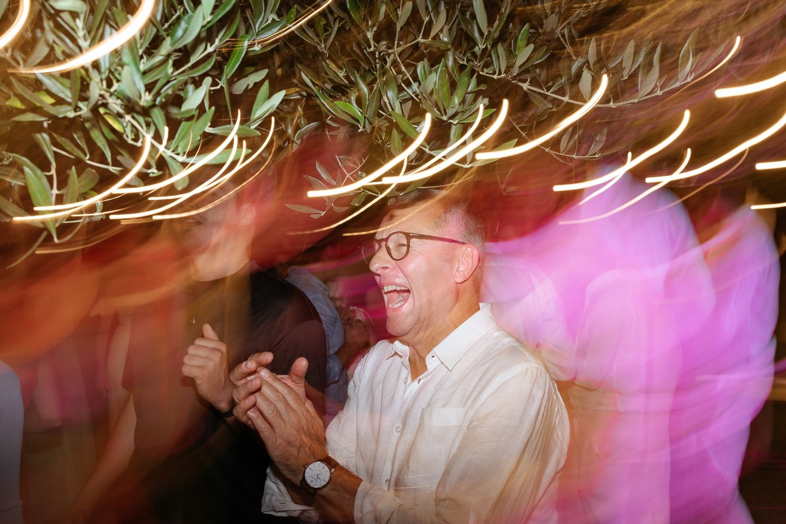 Guests dancing under coloured lights