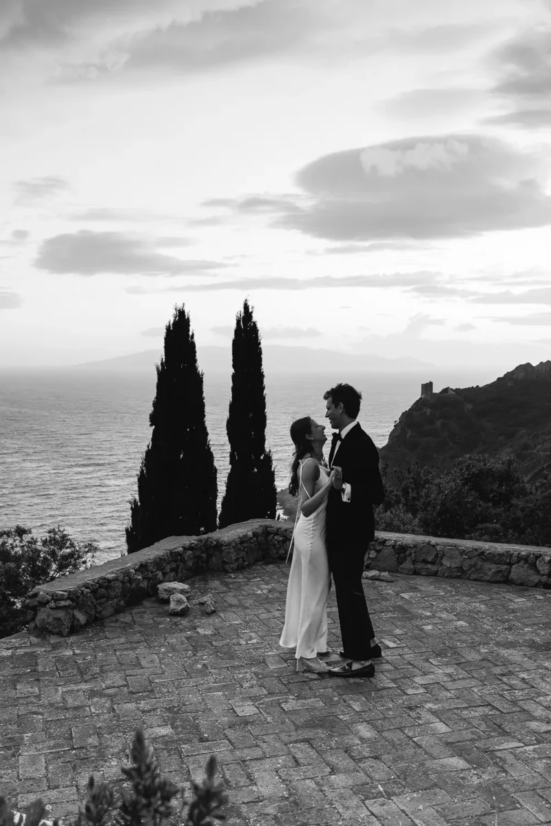 bride and groom are dancing after the ceremony in a terrace facing the sea on the argentario