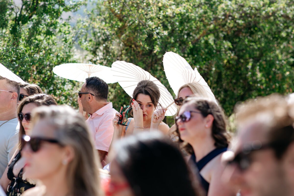 Guests watching the ceremony in the sun