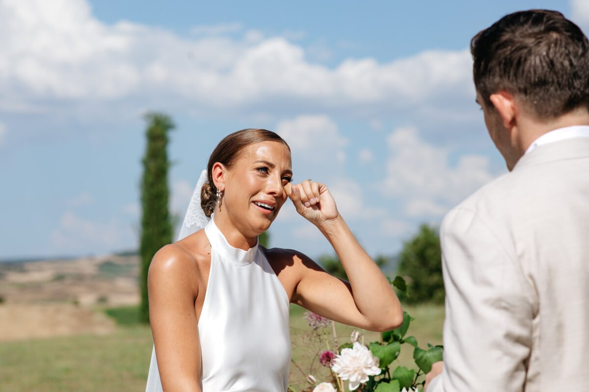 Bride wiping away a tear during the vows