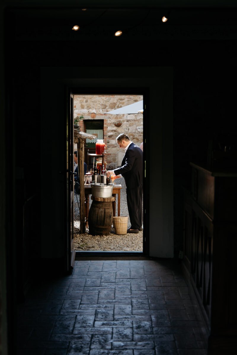 Dark doorway framing guests in the courtyard