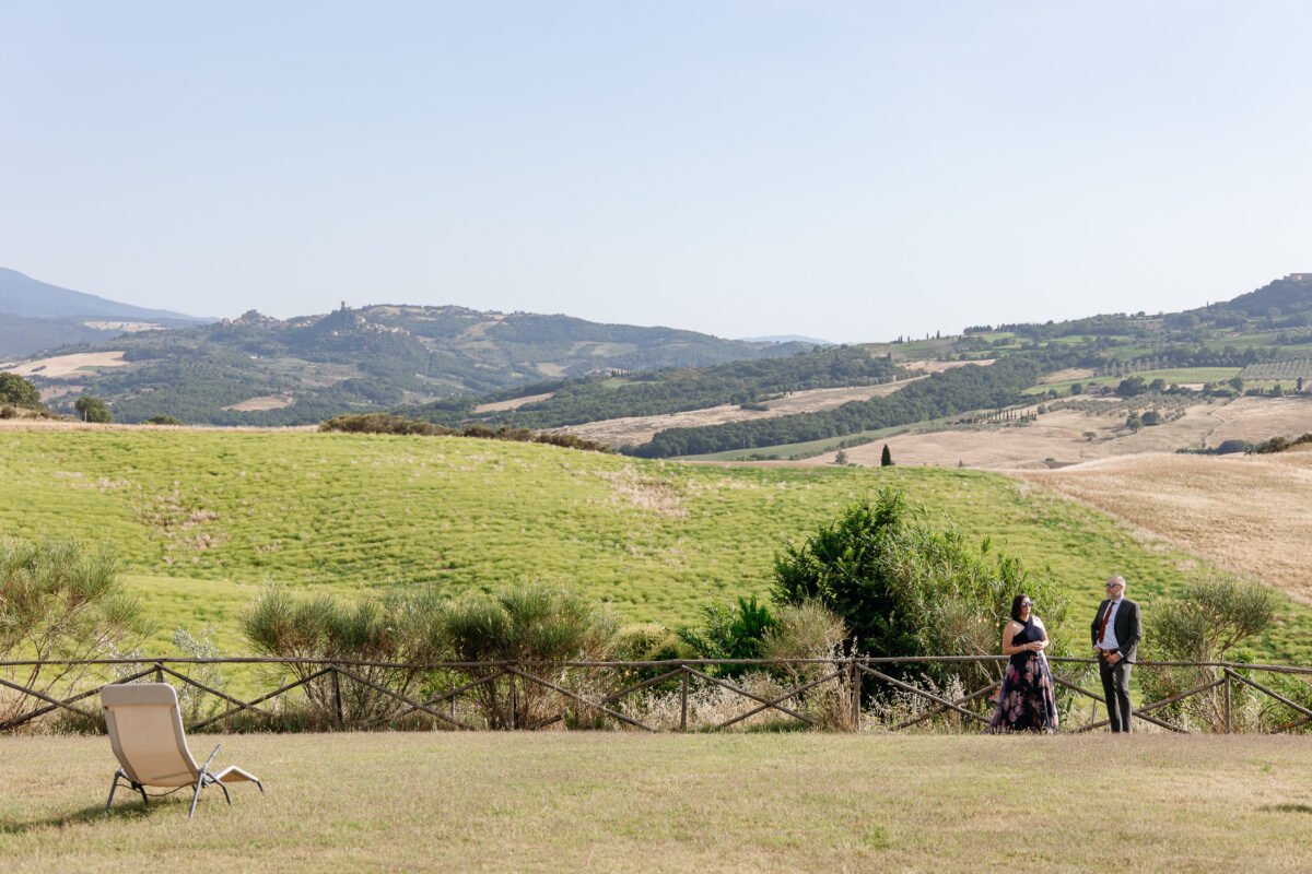 Guests on the lawn with the Val d'Orcia landscape behind