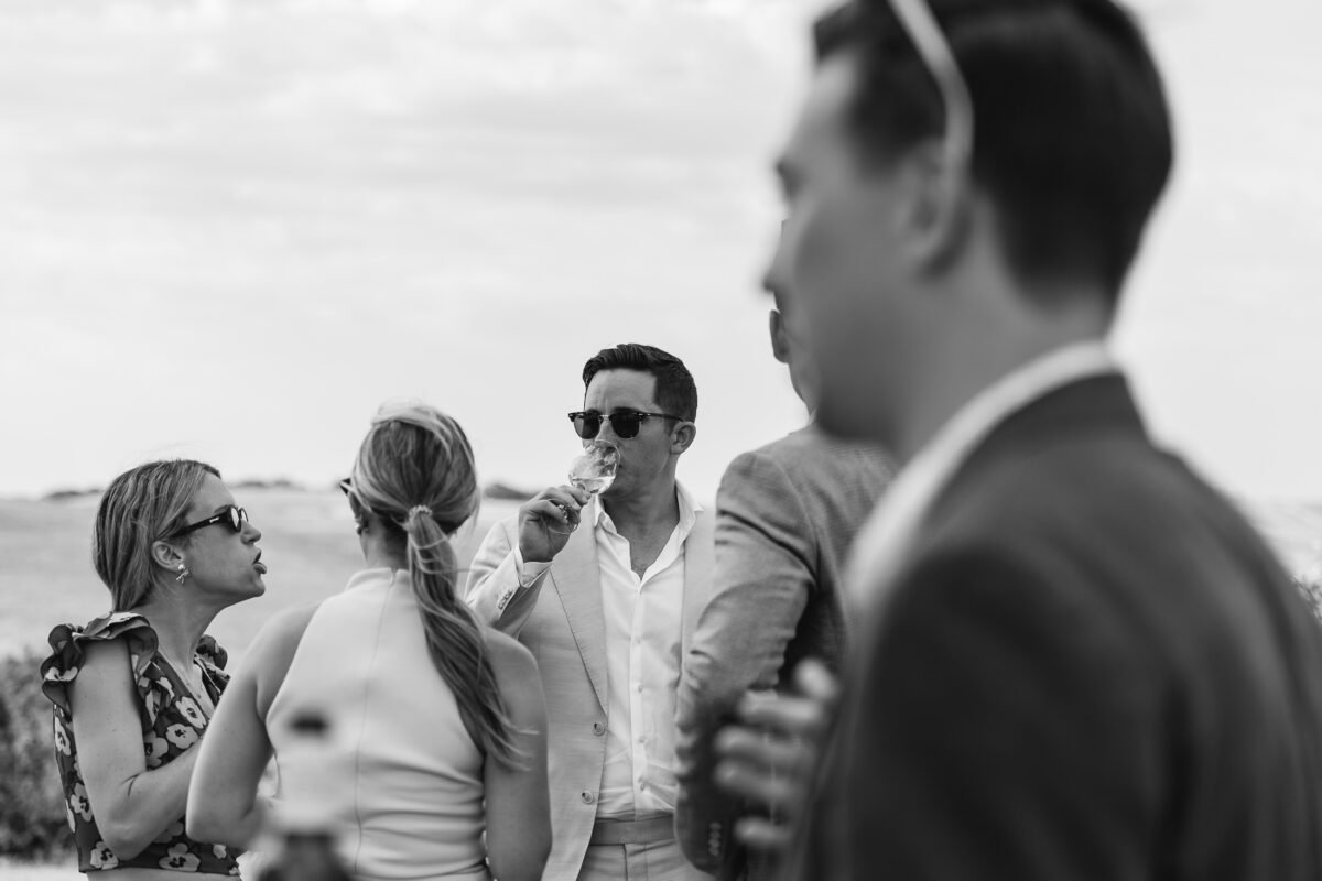 Guests laughing during the aperitivo, black and white