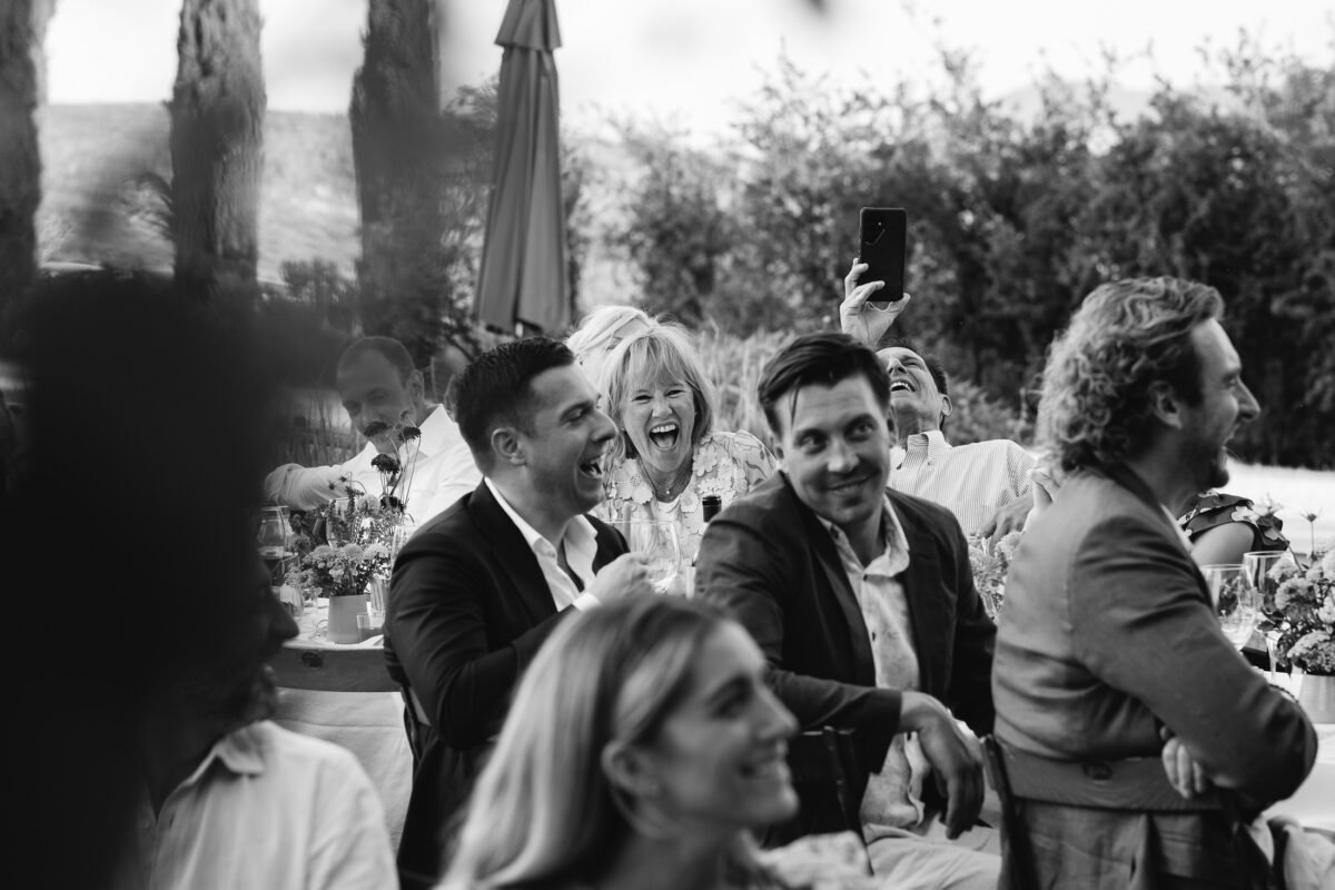 Guests laughing at the table, black and white