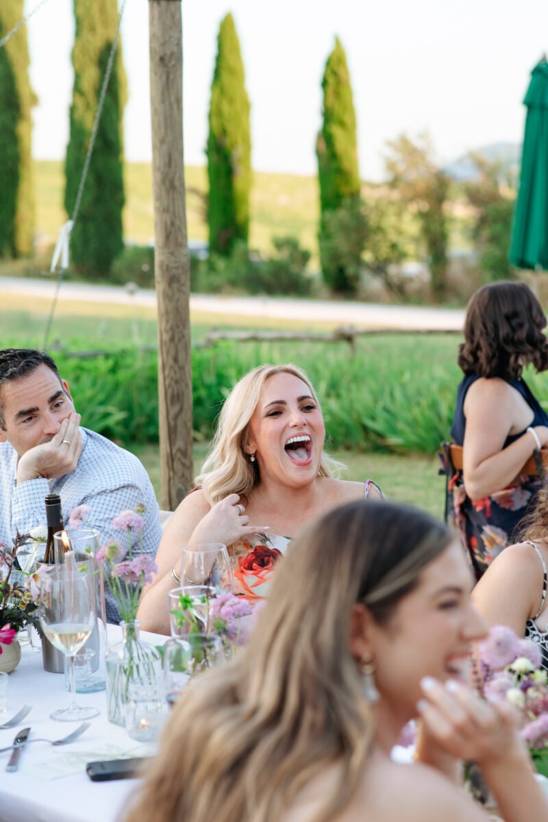 Bride laughing at the dinner table