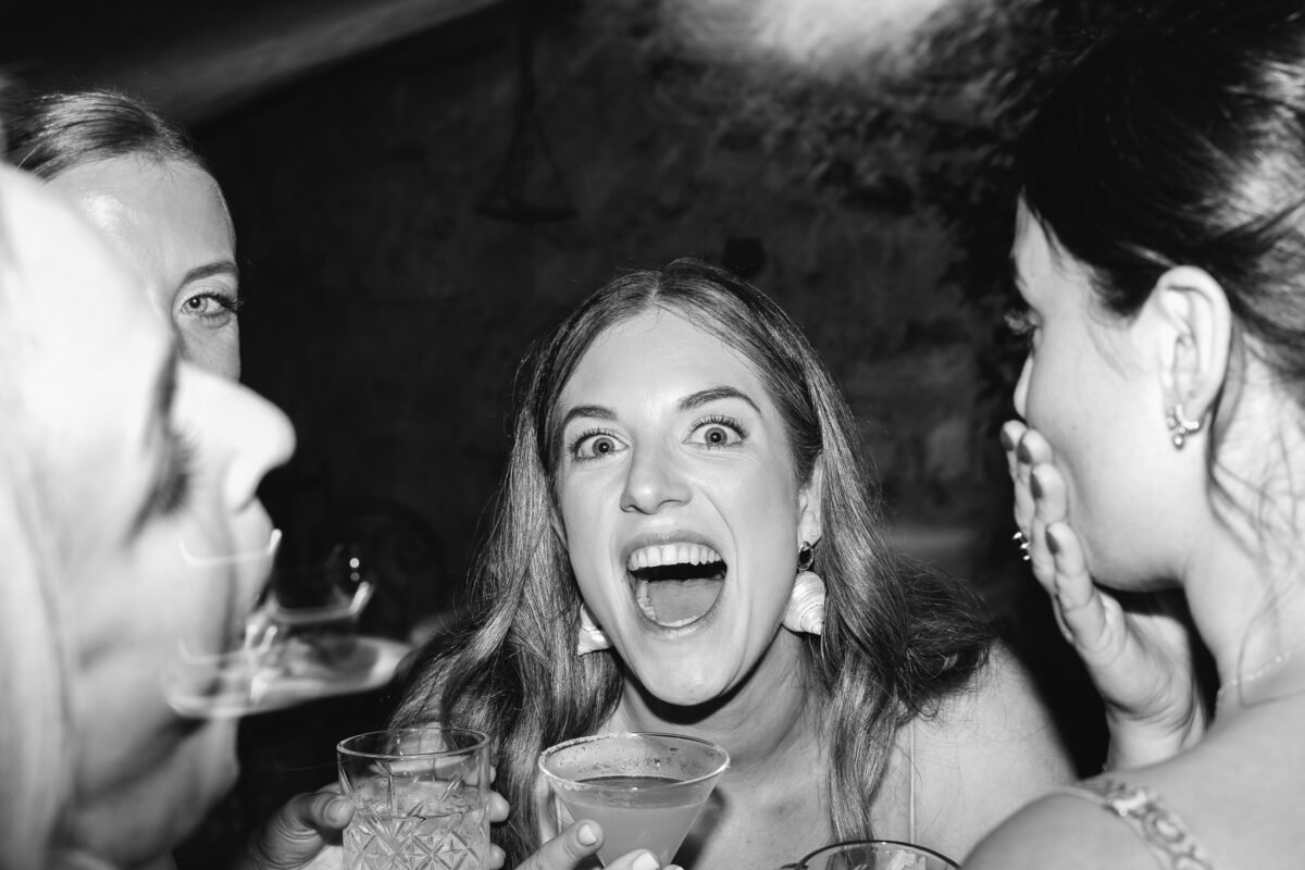 Guests singing on the dance floor, black and white