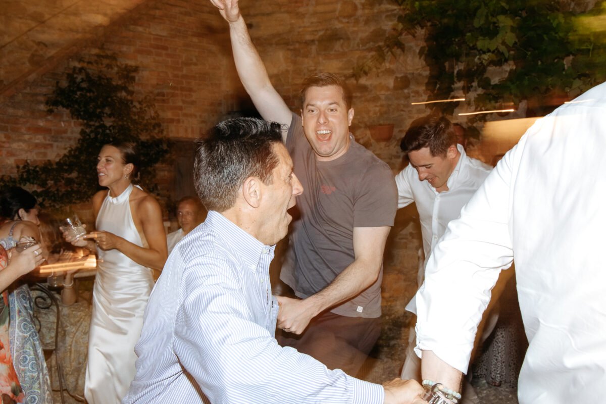 Groom dancing with guests
