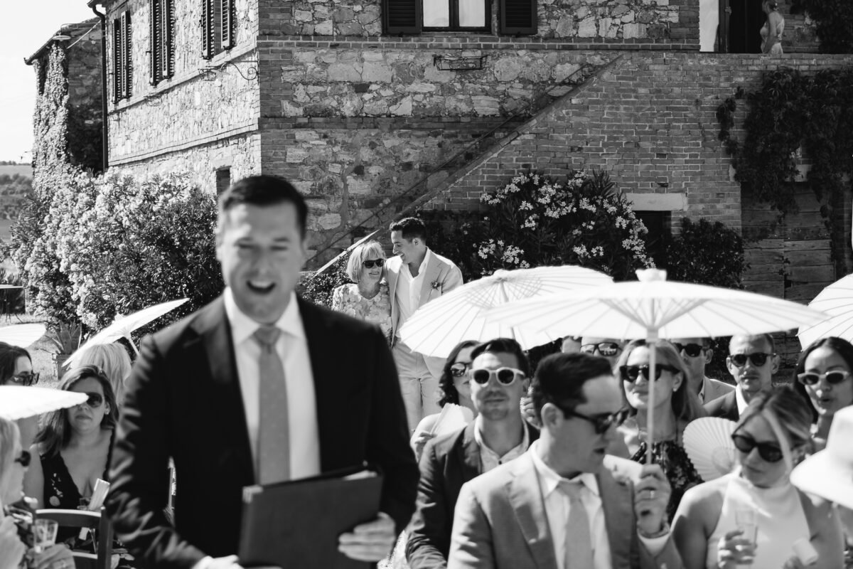 Groom greeting guests before the ceremony, black and white