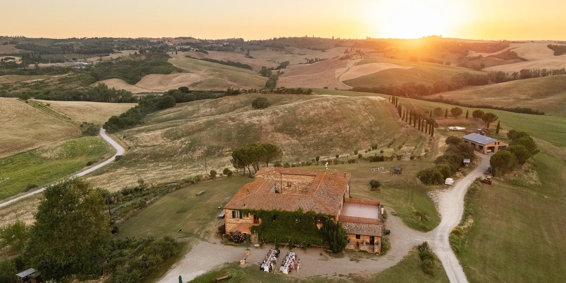 Intimate wedding dinner at sunset at Agriturismo Il Rigo, San Quirico d'Orcia, Tuscany