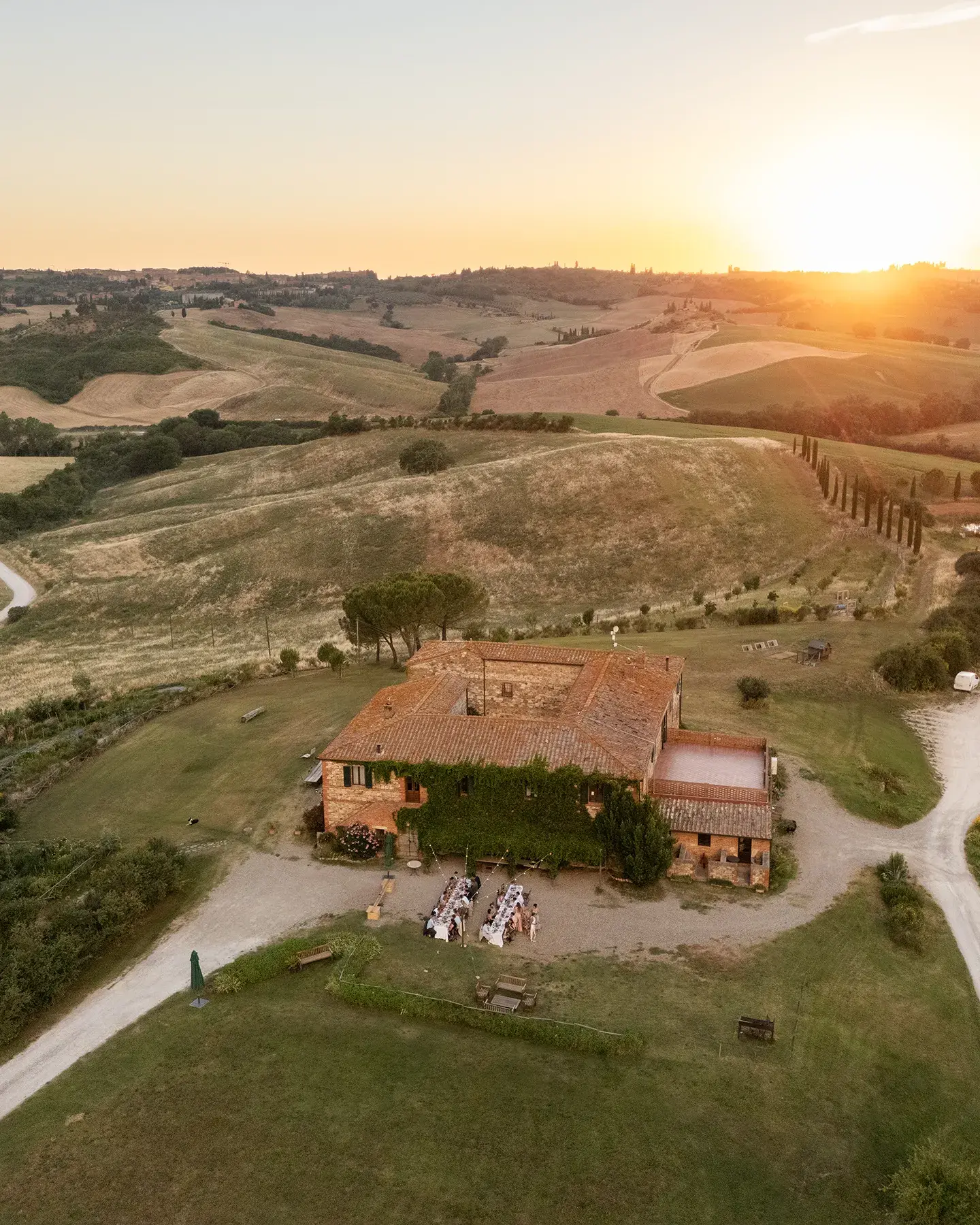Intimate wedding dinner at sunset at Agriturismo Il Rigo, San Quirico d'Orcia, Tuscany