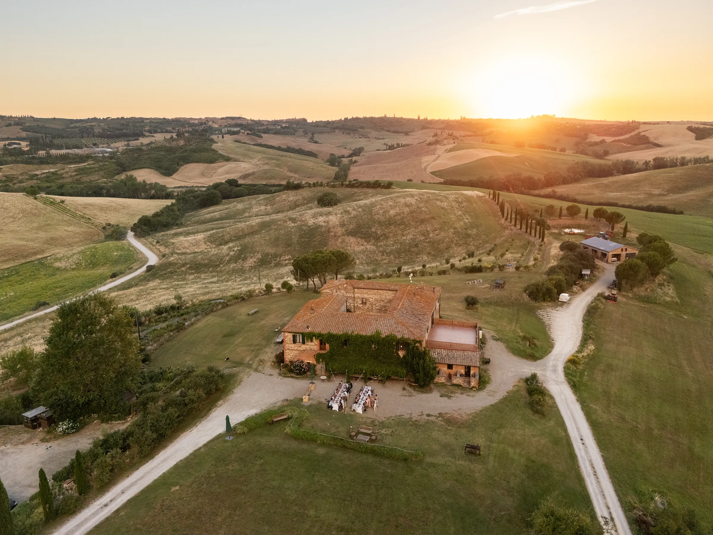 Intimate wedding dinner at sunset at Agriturismo Il Rigo, San Quirico d'Orcia, Tuscany